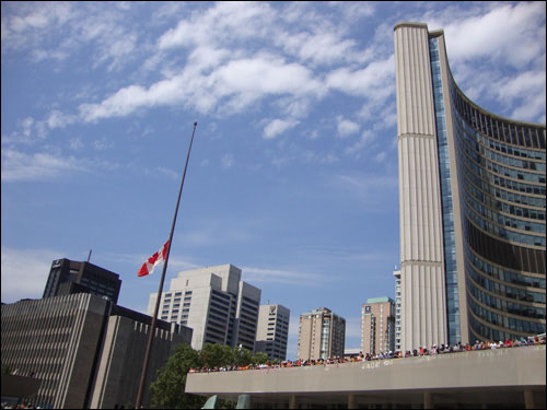 Jack Layton mourners at Toronto City Hall, Canadian flag at half mast